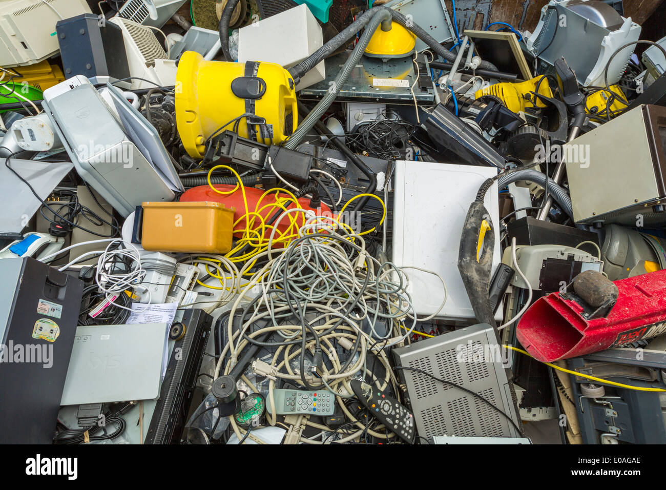 Small electrical appliances laying in a container, for recycling into new items and materials to reduce waste and salvage valuable parts, London, UK Stock Photo