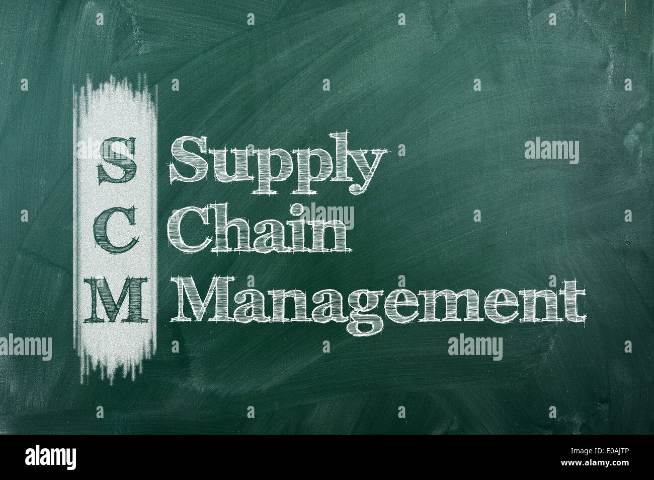 SCM Supply Chain Management acronym written on chalkboard blackboard.  Stock Photo