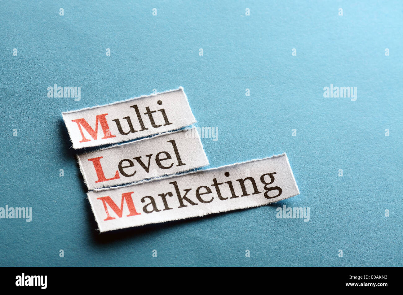 mlm - multi level marketing on blue paper Stock Photo