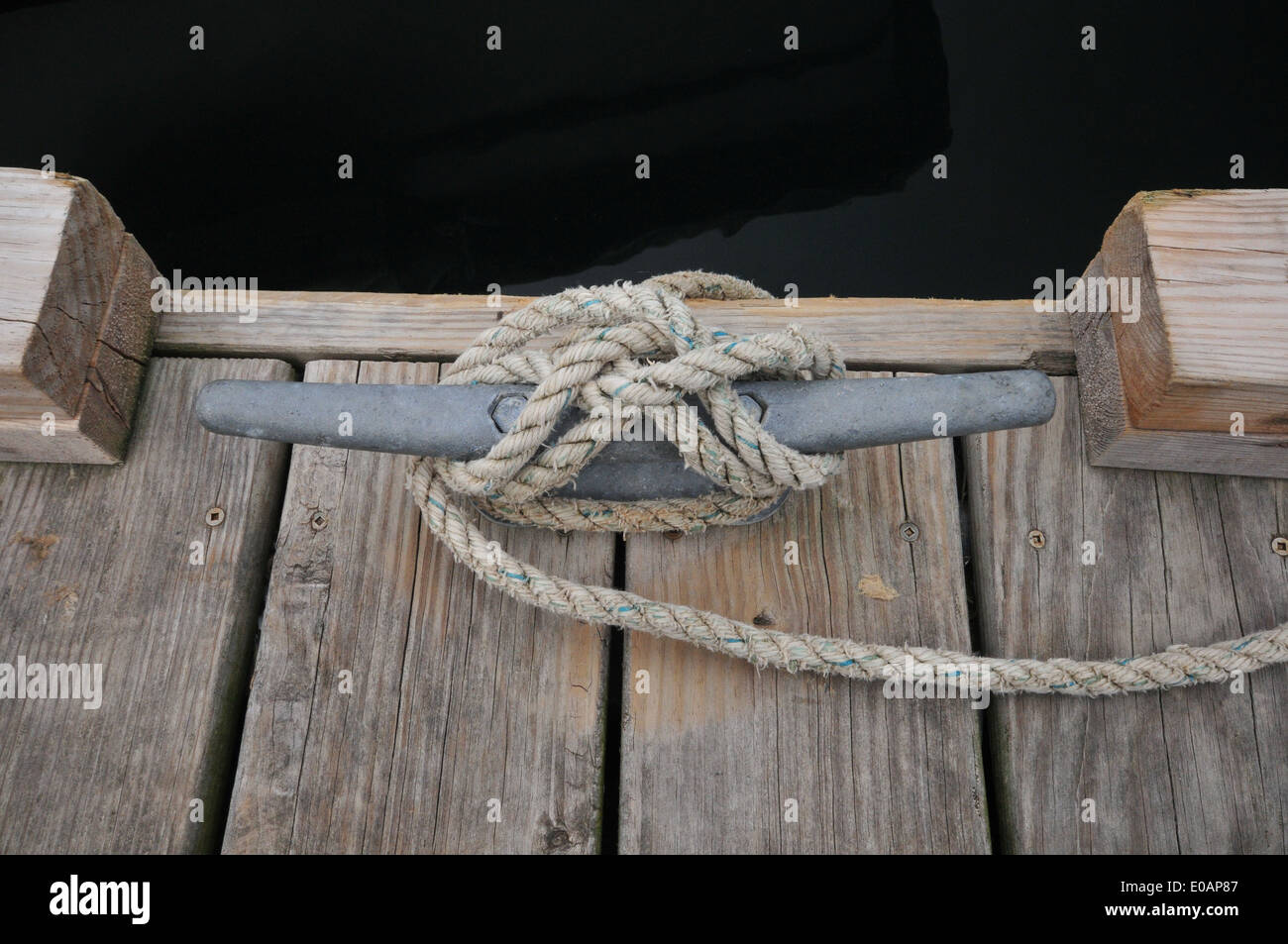 A rope mooring securing a boat to a dock Stock Photo Alamy