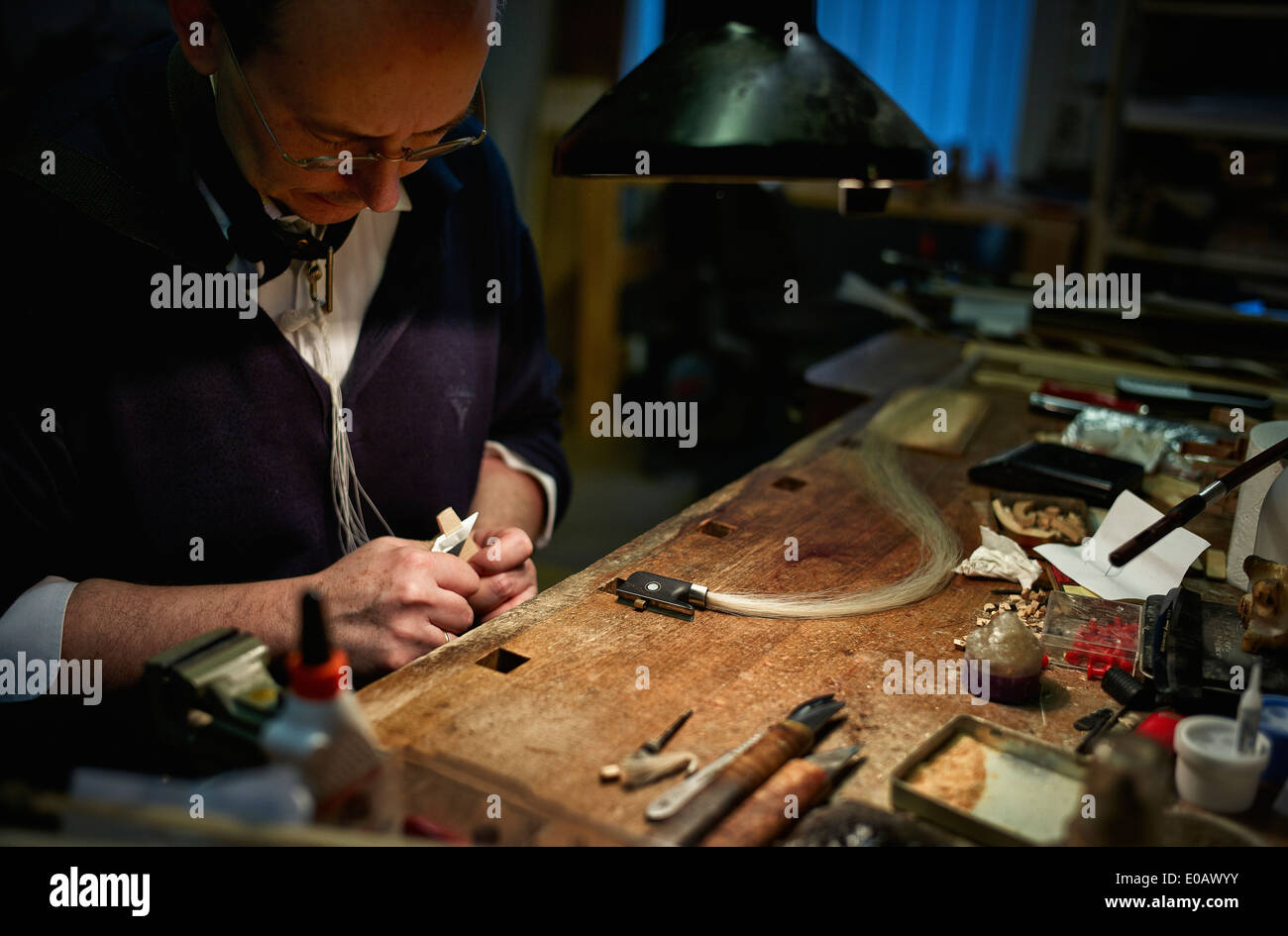 Violin maker repairing a bow Stock Photo Alamy