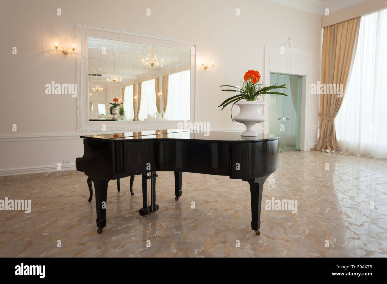 a luxurious black grand piano in a modern and bright hall Stock Photo ...