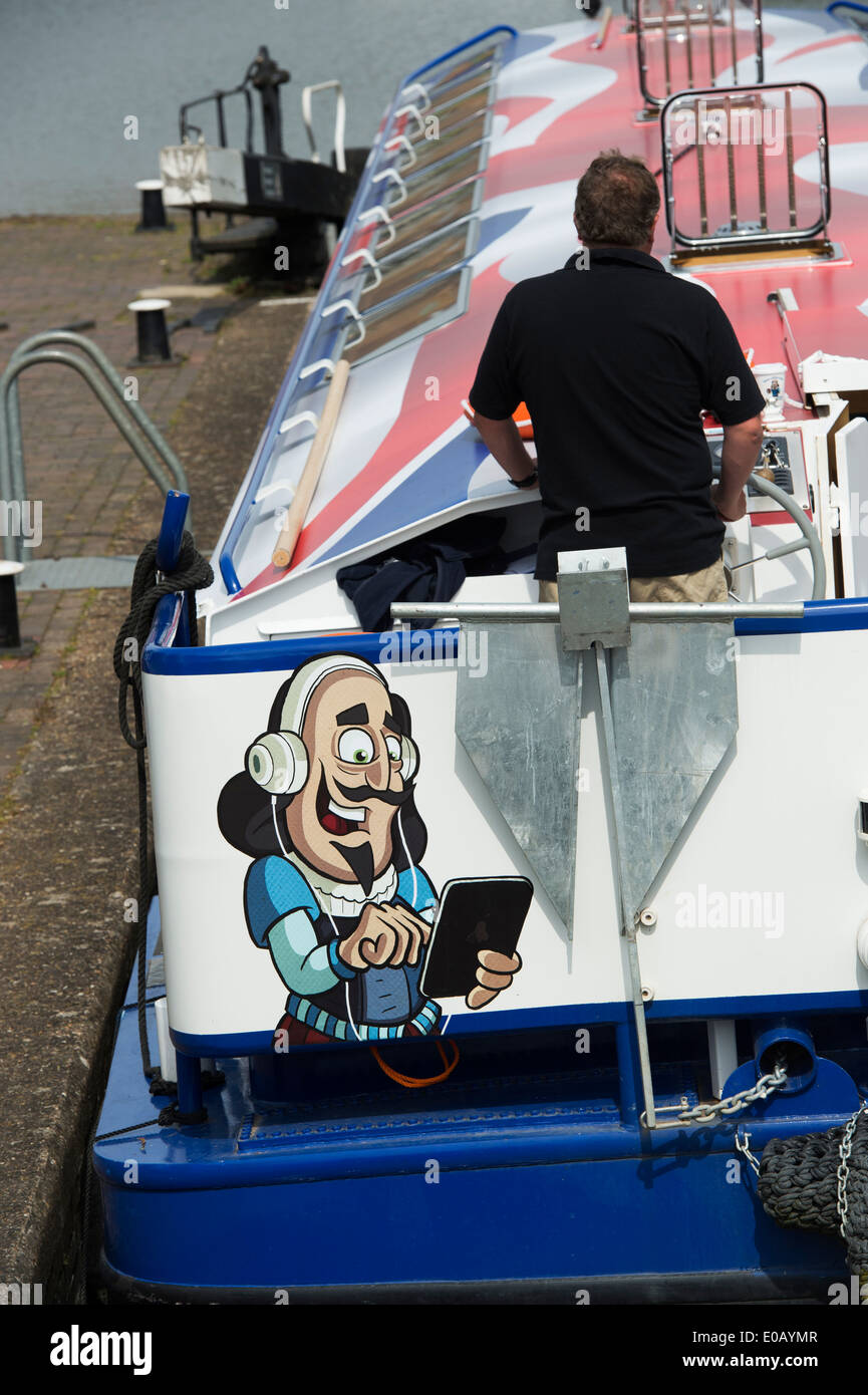 Shakespeare using a tablet cartoon on the rear of a Canal River Tour Barge in the lock at Stratford Upon Avon, England Stock Photo