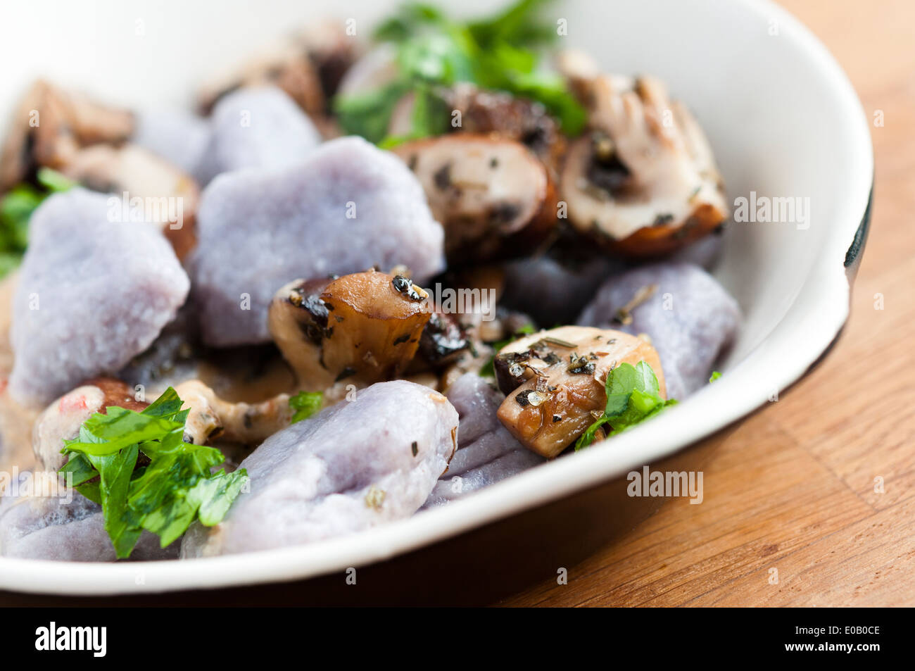 Purple potato gnocchi with chestnut mushrooms Stock Photo