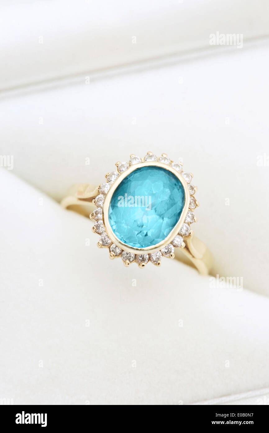 Gold ring with blue topaz and diamonds in jewel box Stock Photo