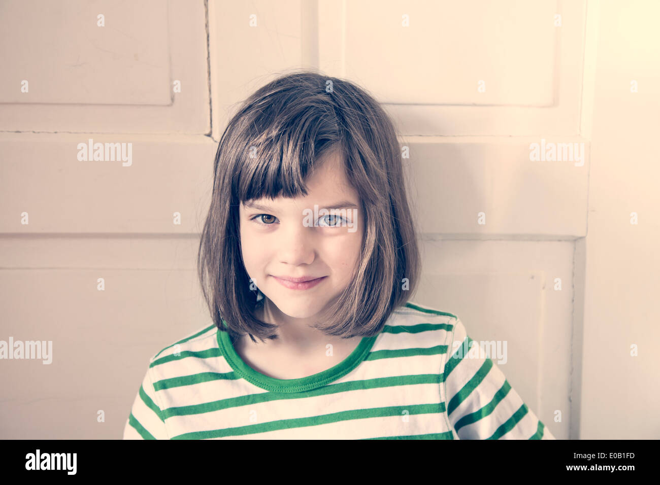 Portrait of smiling little girl at home Stock Photo - Alamy