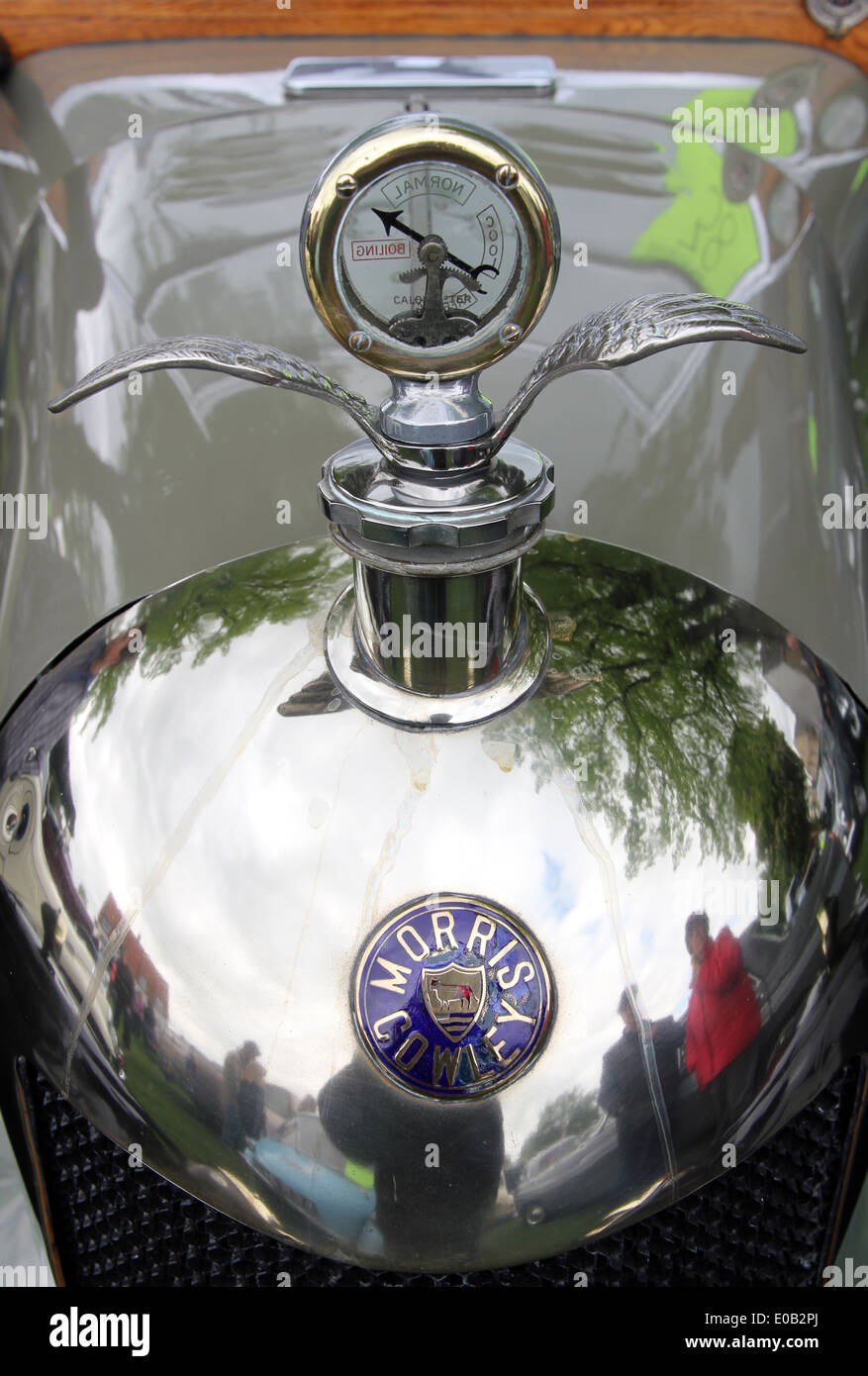 classic winged pressure gauge radiator cap on bonnet of vintage car Morris Cowley Stock Photo