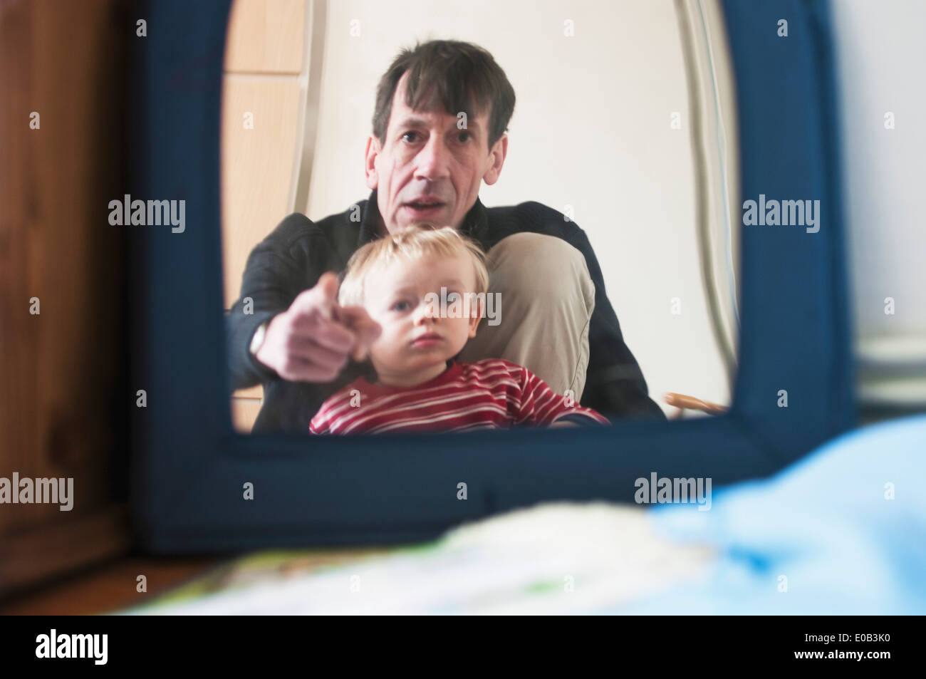 Germany, Father and son looking in mirror Stock Photo