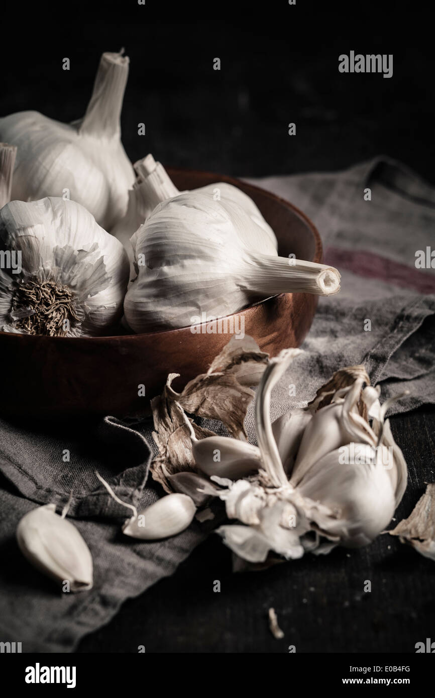 Garlic cloves and bulbs against dark background Stock Photo - Alamy
