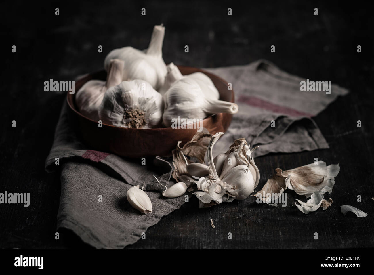 Garlic cloves and bulbs against dark background Stock Photo - Alamy