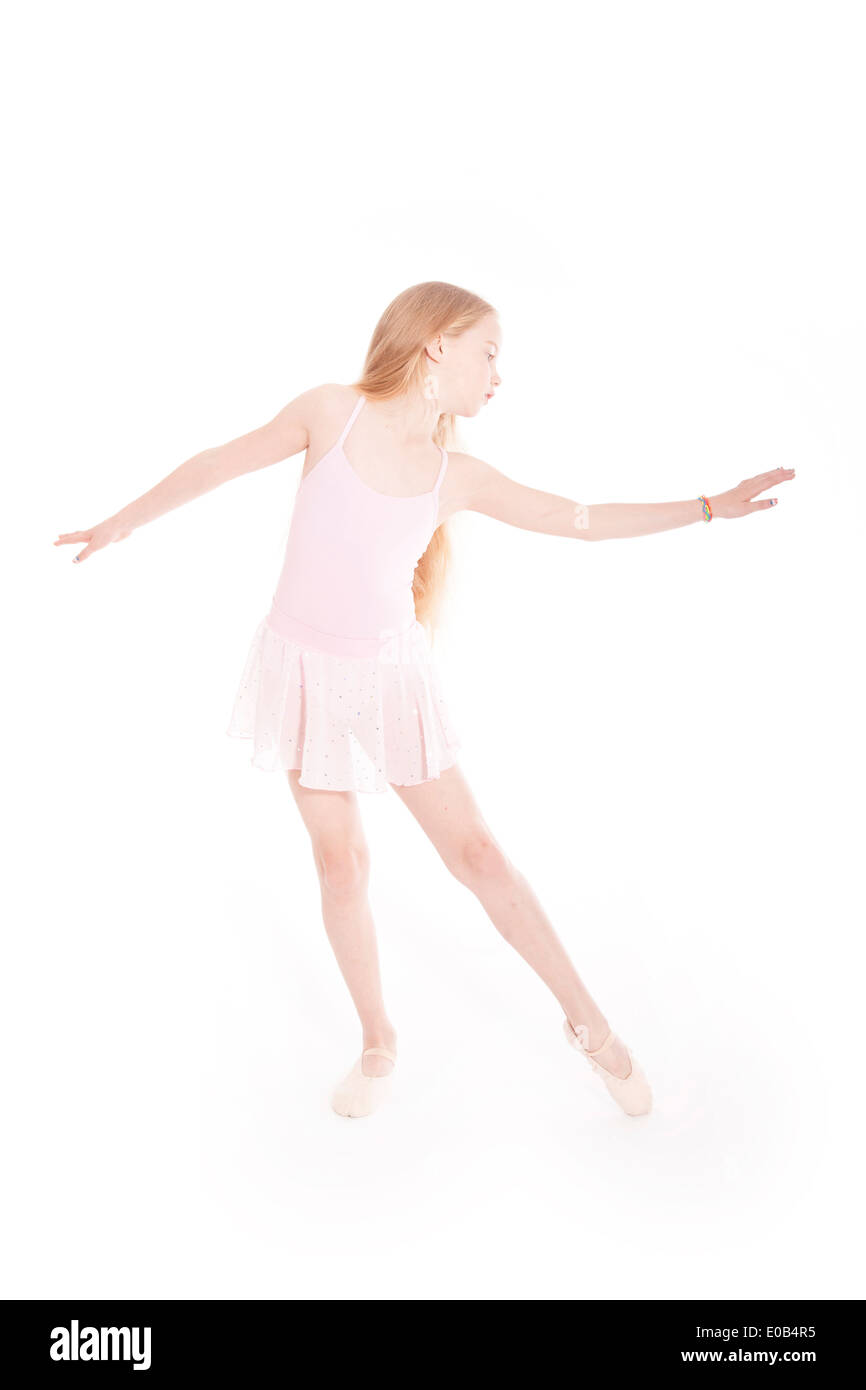 girl dancing in pink ballet suit in studio with white background Stock Photo