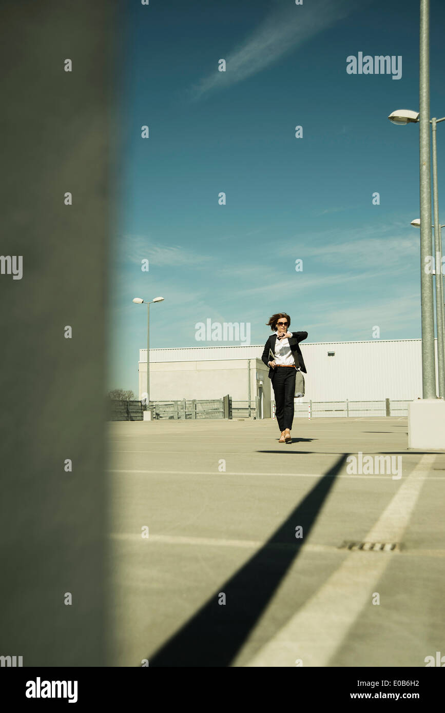 Business woman hurrying on parking level Stock Photo