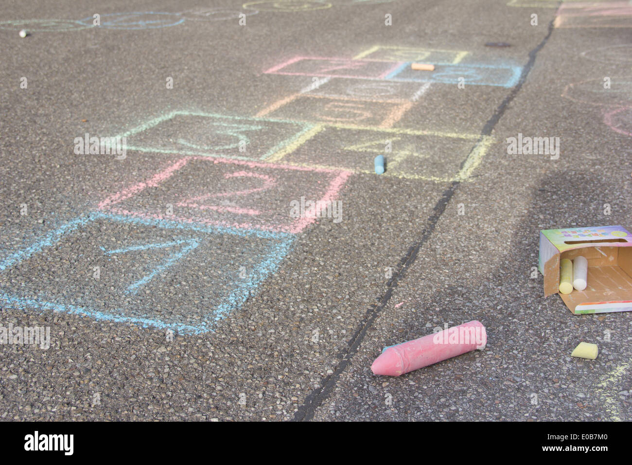 Hopscotch drawing with coloured crayon on asphalt Stock Photo