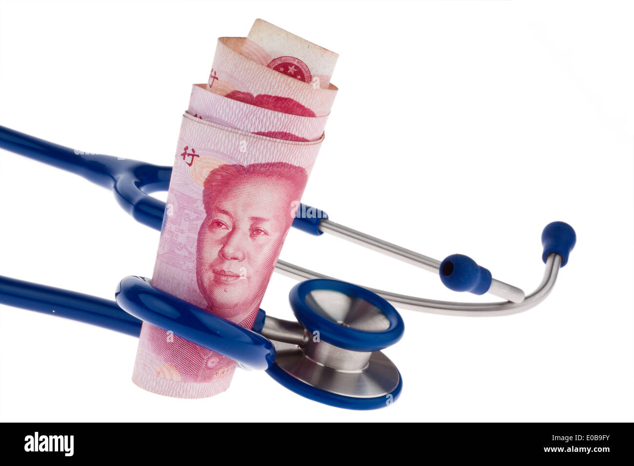 Chinese yuan of bank notes and Stethoskop. Costs for health, Chinesische Yuan Banknoten und Stethoskop. Kosten fuer Gesundheit Stock Photo