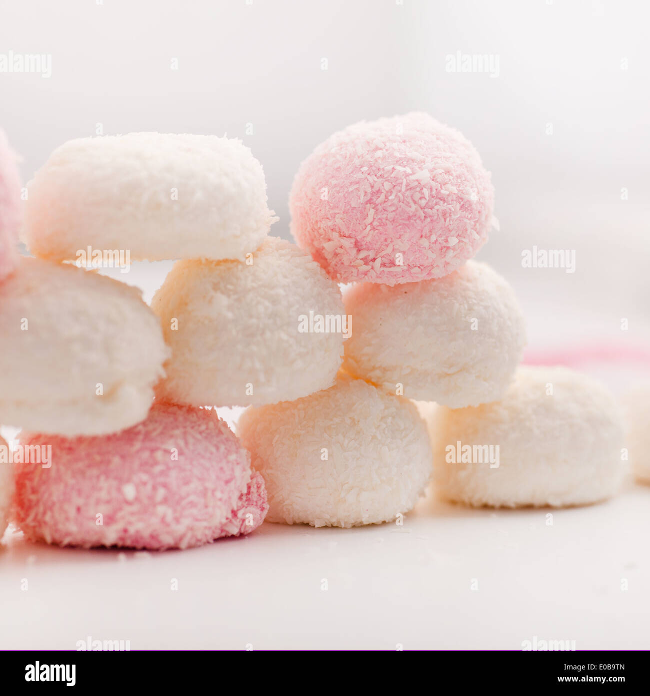 Stacked pink and white candy ciovered in dried coconut for a festive or