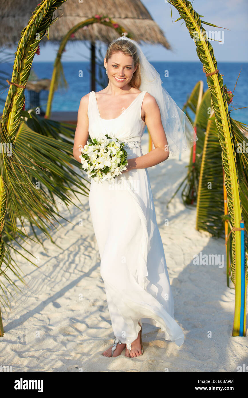 Beautiful Bride Getting Married In Beach Ceremony Stock Photo