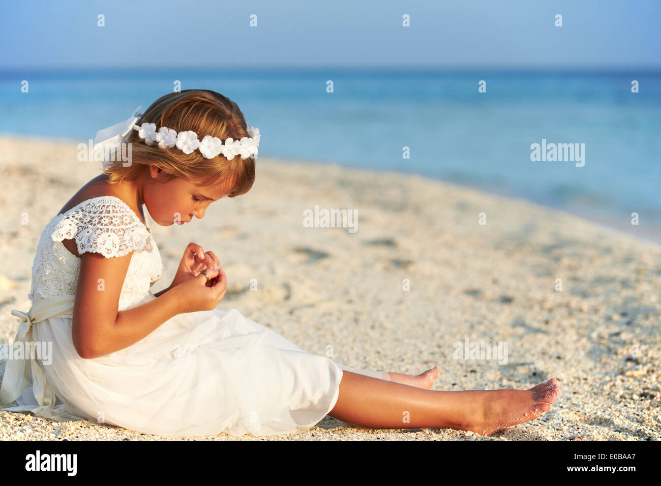 Bridesmaid Sitting On Beach At Wedding Ceremony Stock Photo