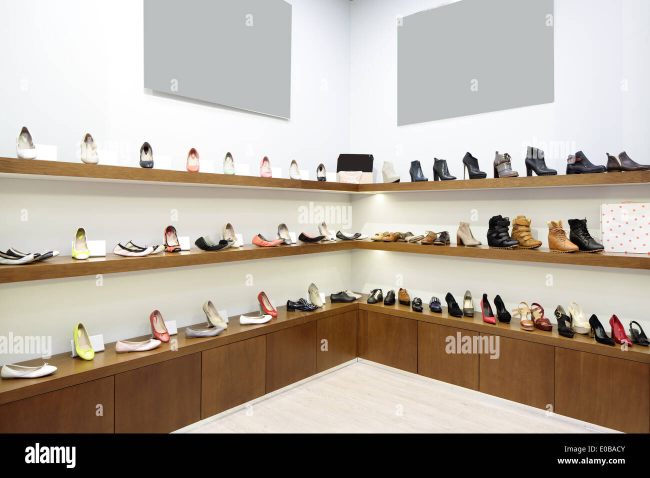 bright and fashionable interior of shoe store in modern mall Stock