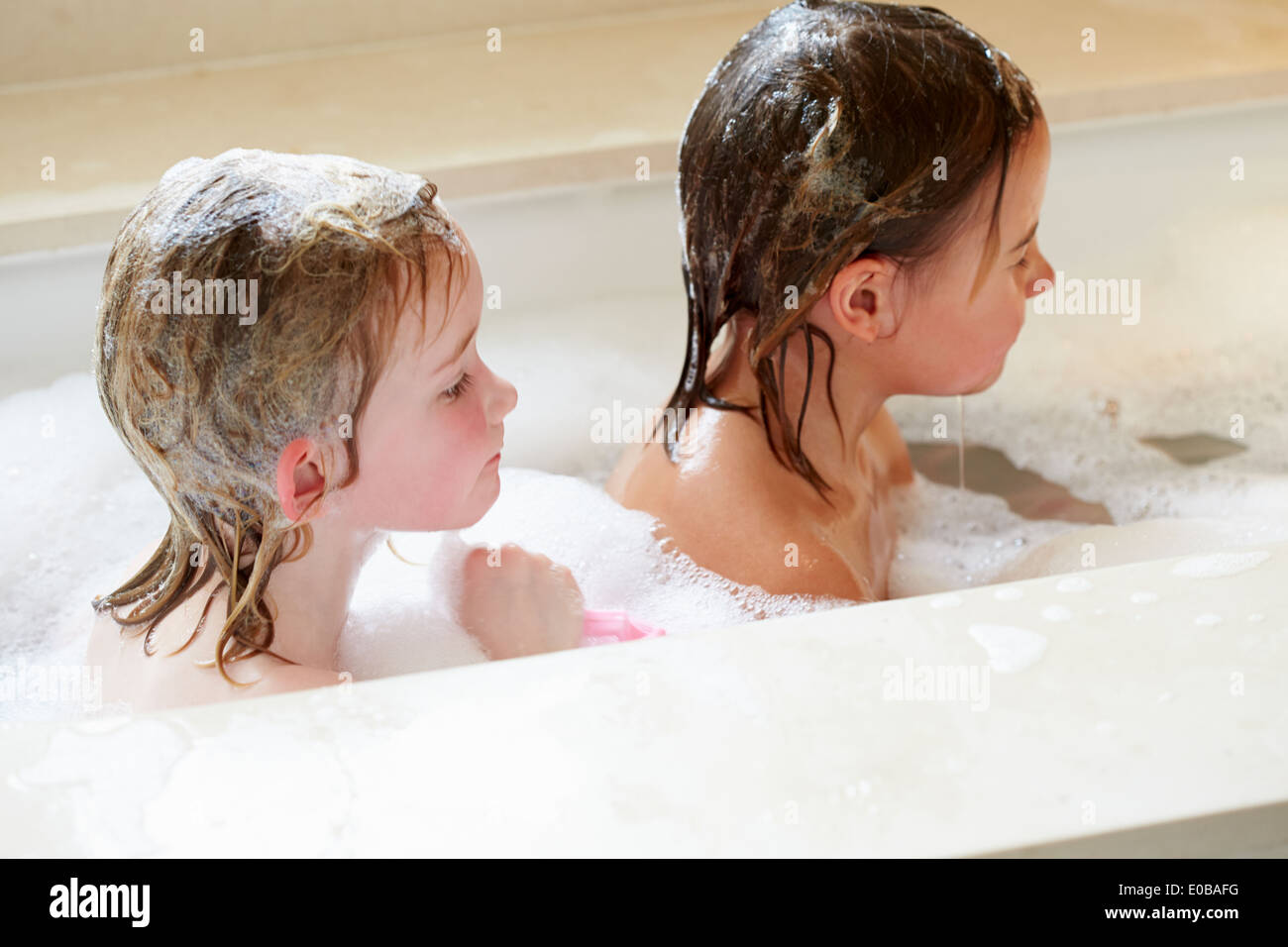Two Girls Sharing Bubble Bath Stock Photo