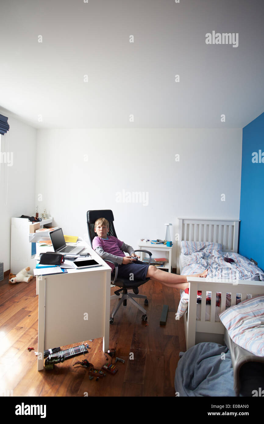 Boy Playing Video Game In Bedroom Stock Photo Alamy