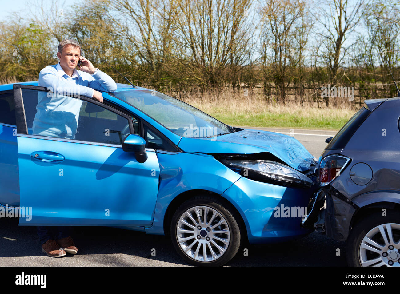 Stressed Driver Sitting At Roadside After Traffic Accident Stock Photo ...