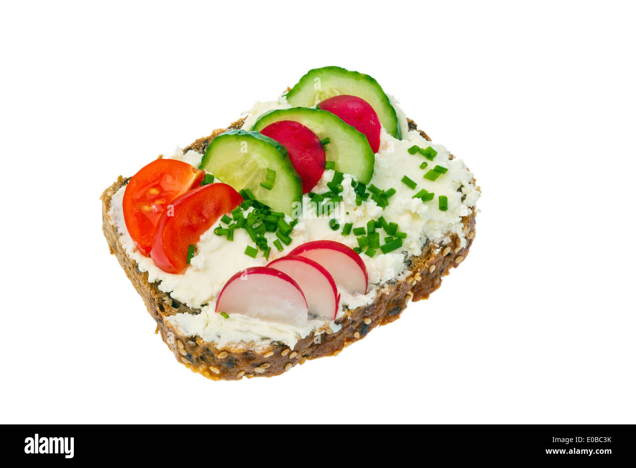 A bread with cream cheese and curd spread and vegetables to the healthy food., Ein Brot mit Topfen und Quarkaufstrich und Gemues Stock Photo