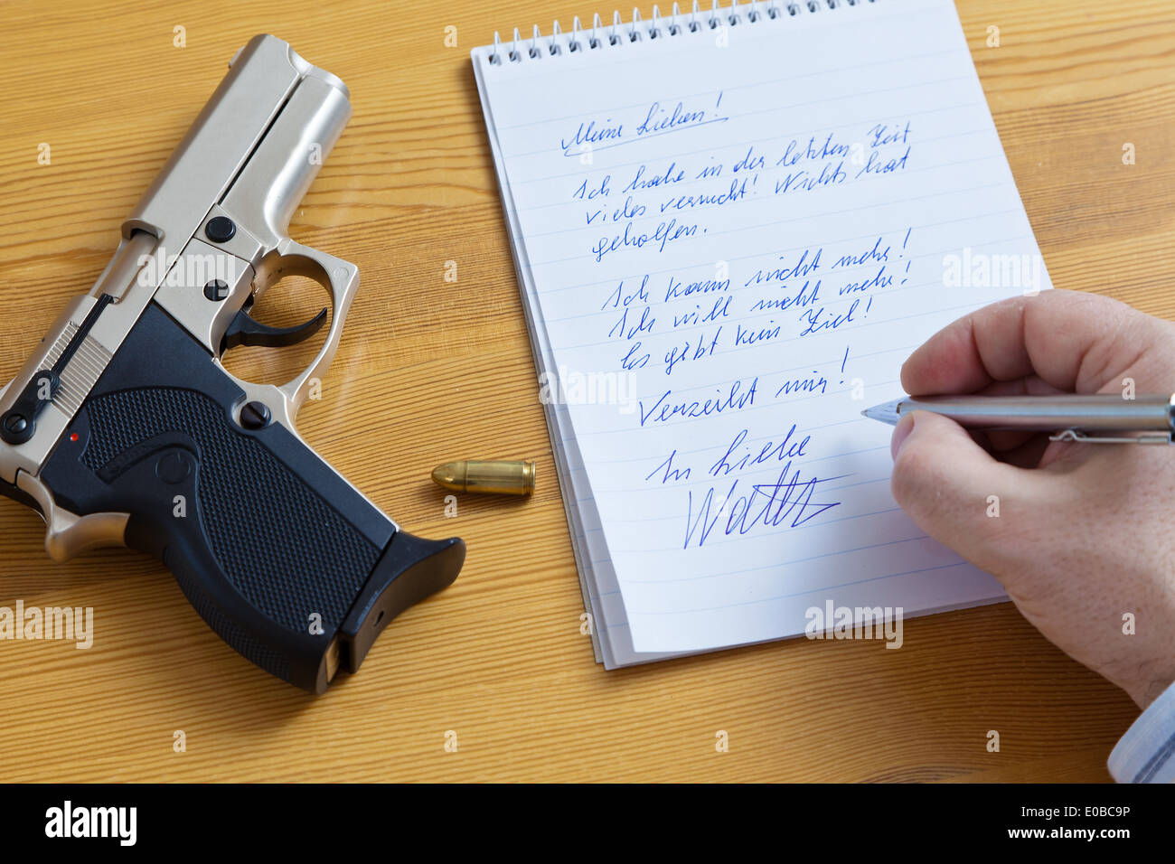 A resignation letter and the gun of a selfmurderer., Ein Abschieds Brief und die Pistole eines Selbstmoerders. Stock Photo