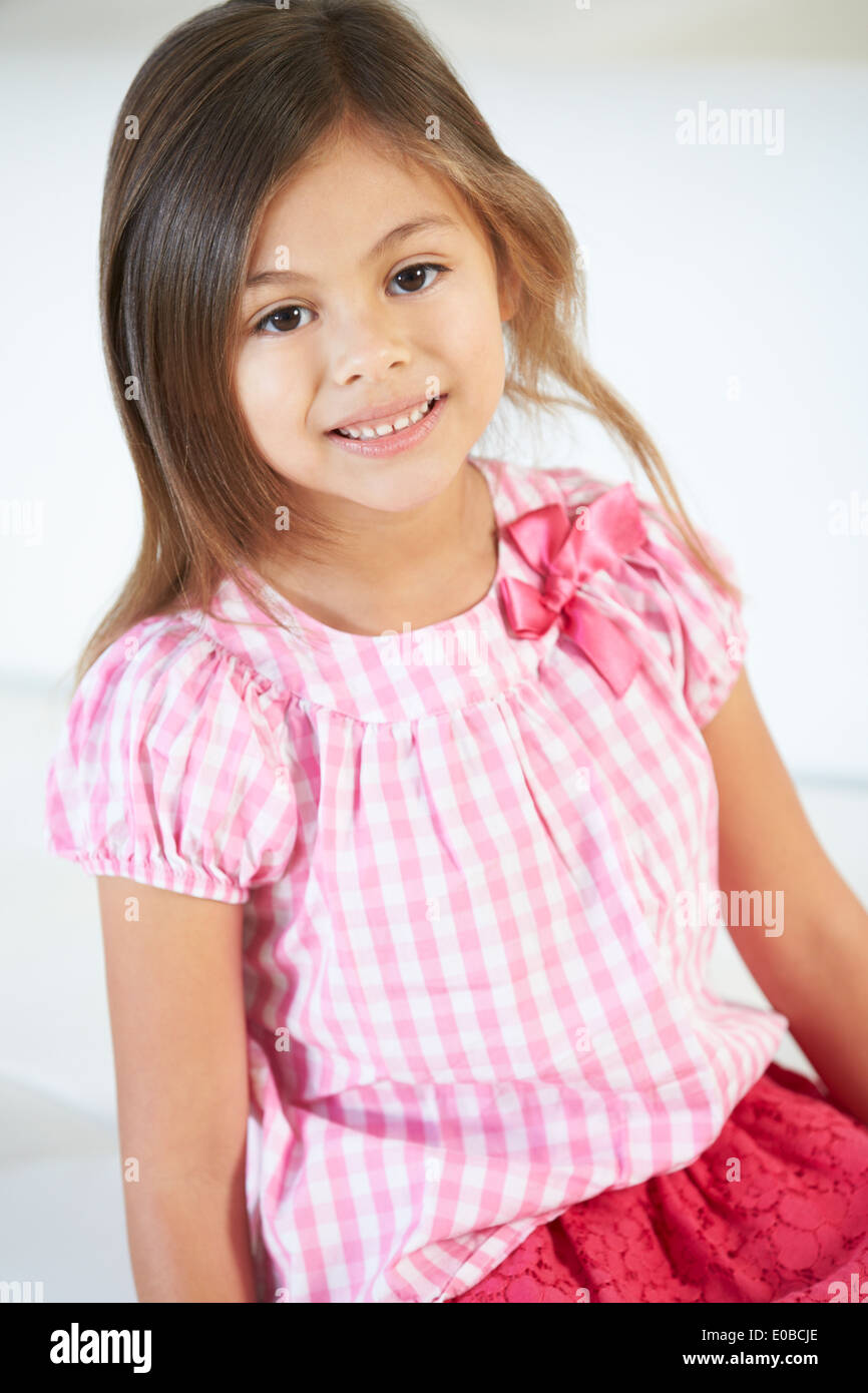 Smiling Girl Sitting On Sofa Stock Photo - Alamy
