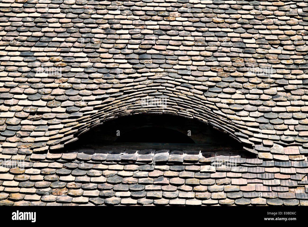 Roof shingles on an old house. Old roof with roofing tiles covered, Dachschindeln auf einem alten Haus. Altes Dach mit Dachziege Stock Photo