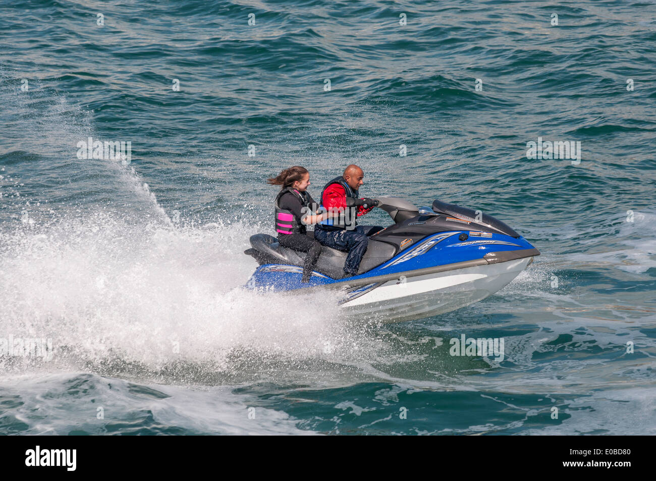 Two people on a jet ski Stock Photo Alamy
