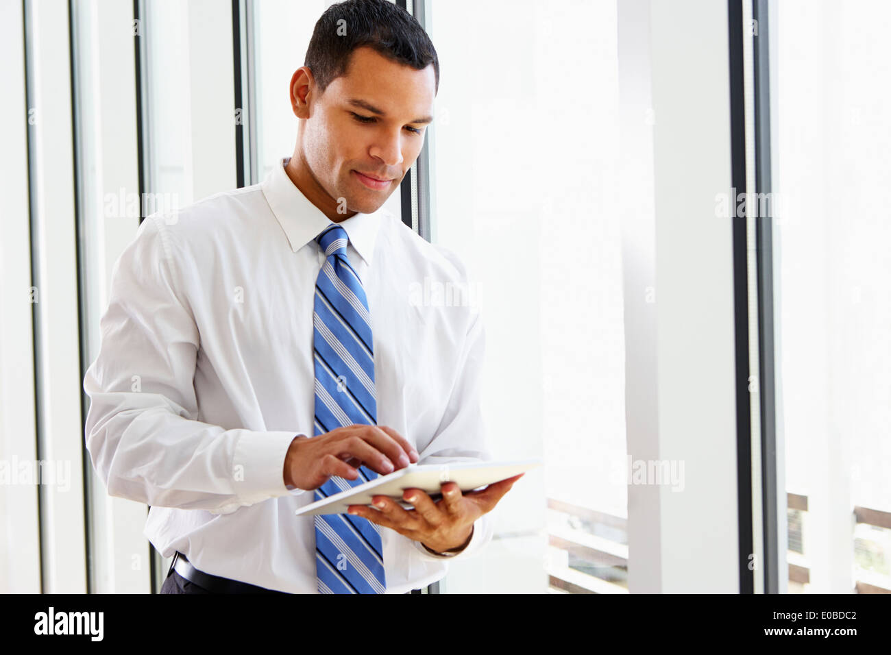 Businessman Using Digital Tablet In Office Stock Photo