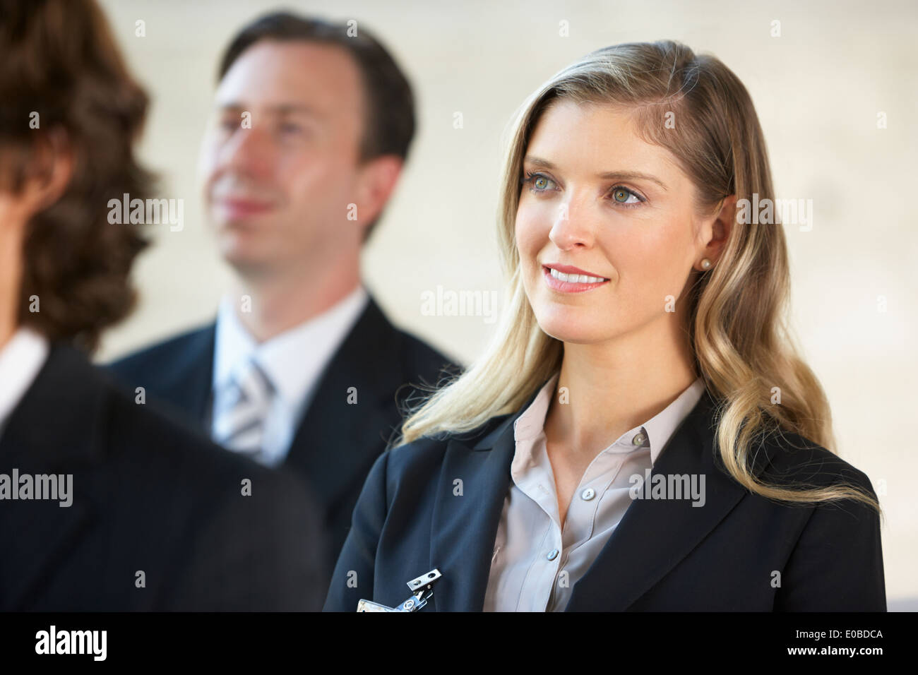 Businesswoman Listening To Speaker At Conference Stock Photo