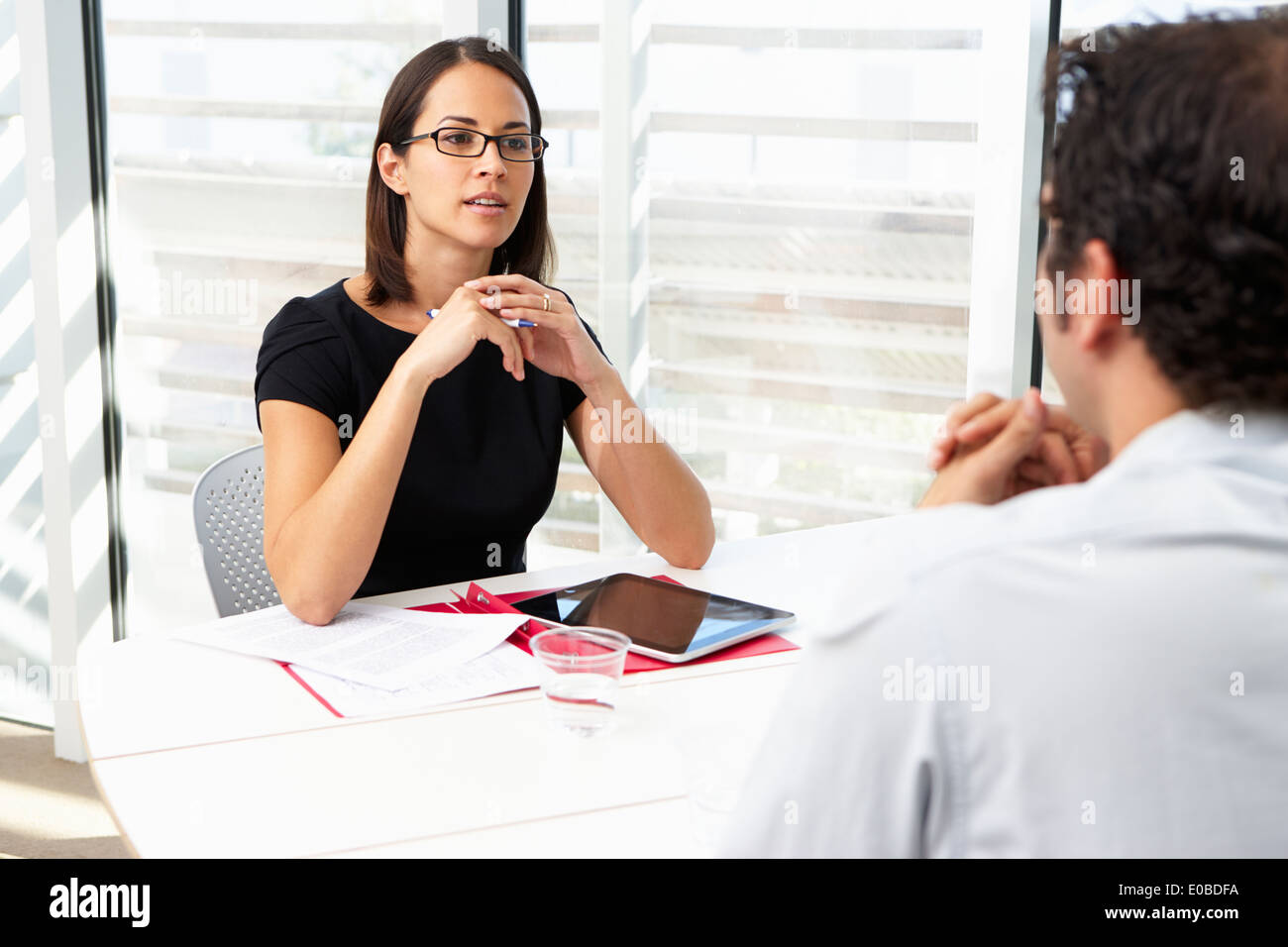 Businesswoman Interviewing Male Candidate For Job Stock Photo