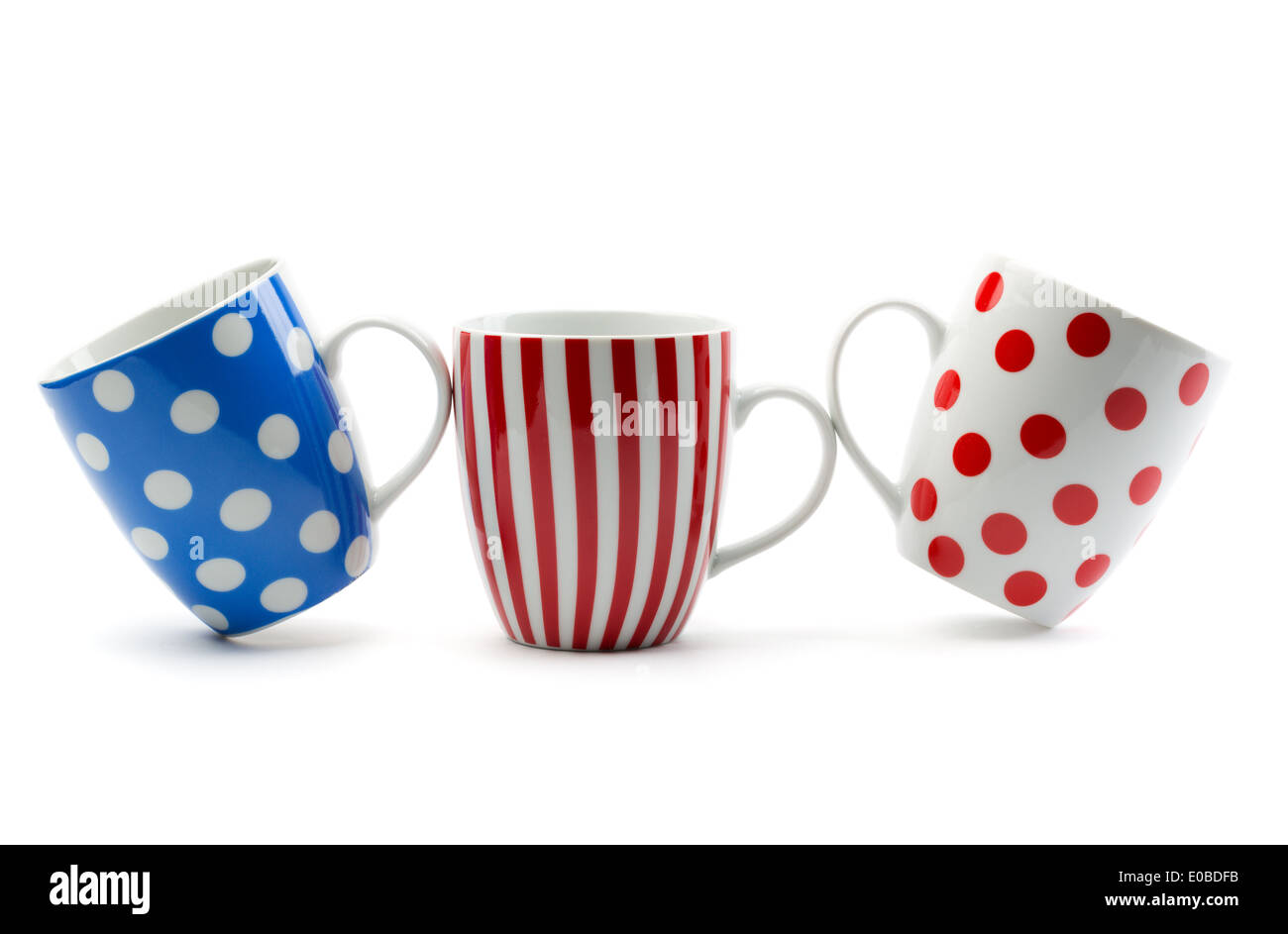 Three porcelain cup with stripes and dots. Isolate on white. Stock Photo