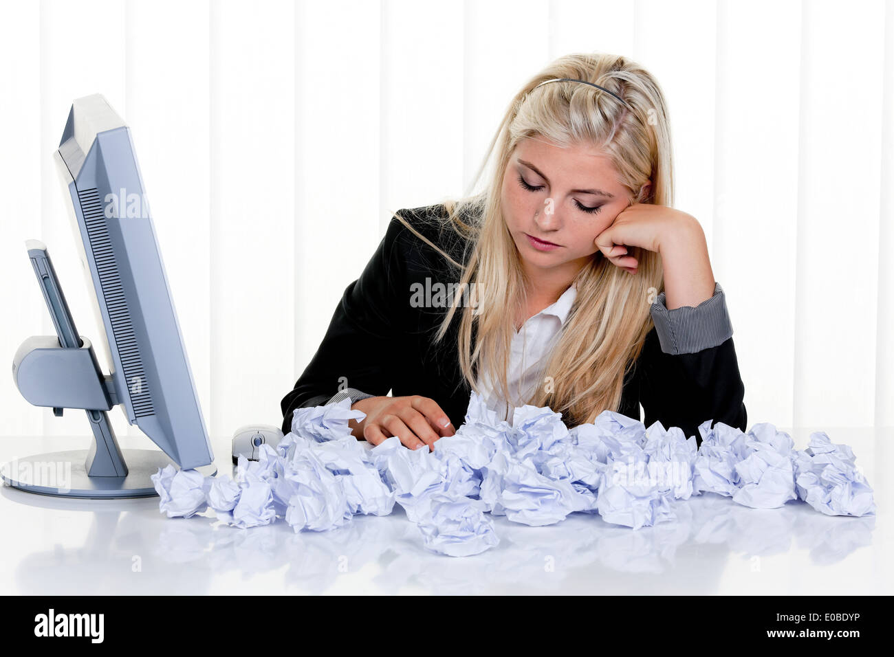Young woman with paper looks for idea. Frustration by Stock Photo