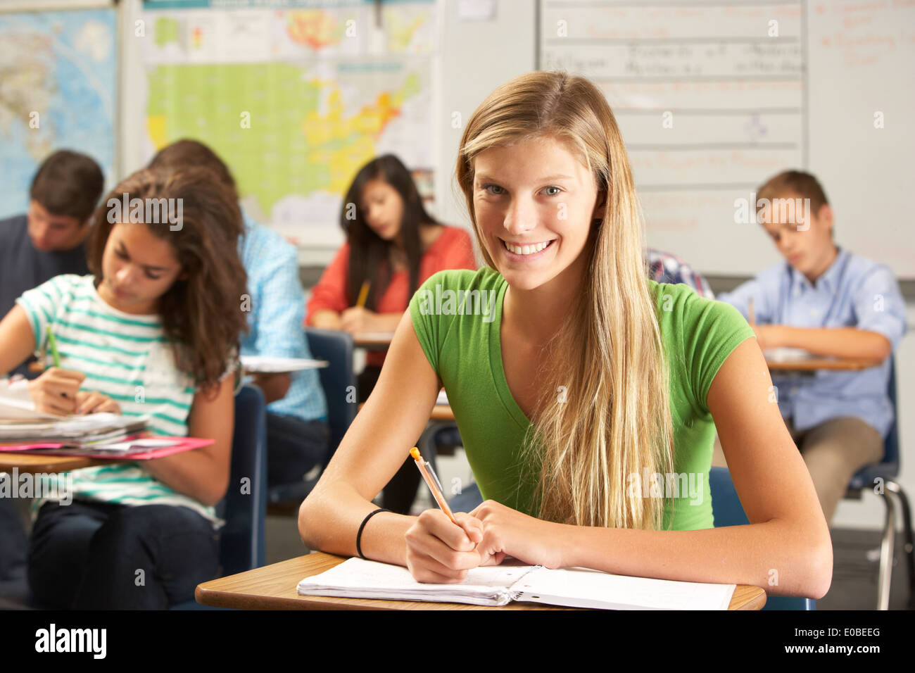 Portrait Of Female Pupil Studying At Desk In Classroom Stock Photo - Alamy