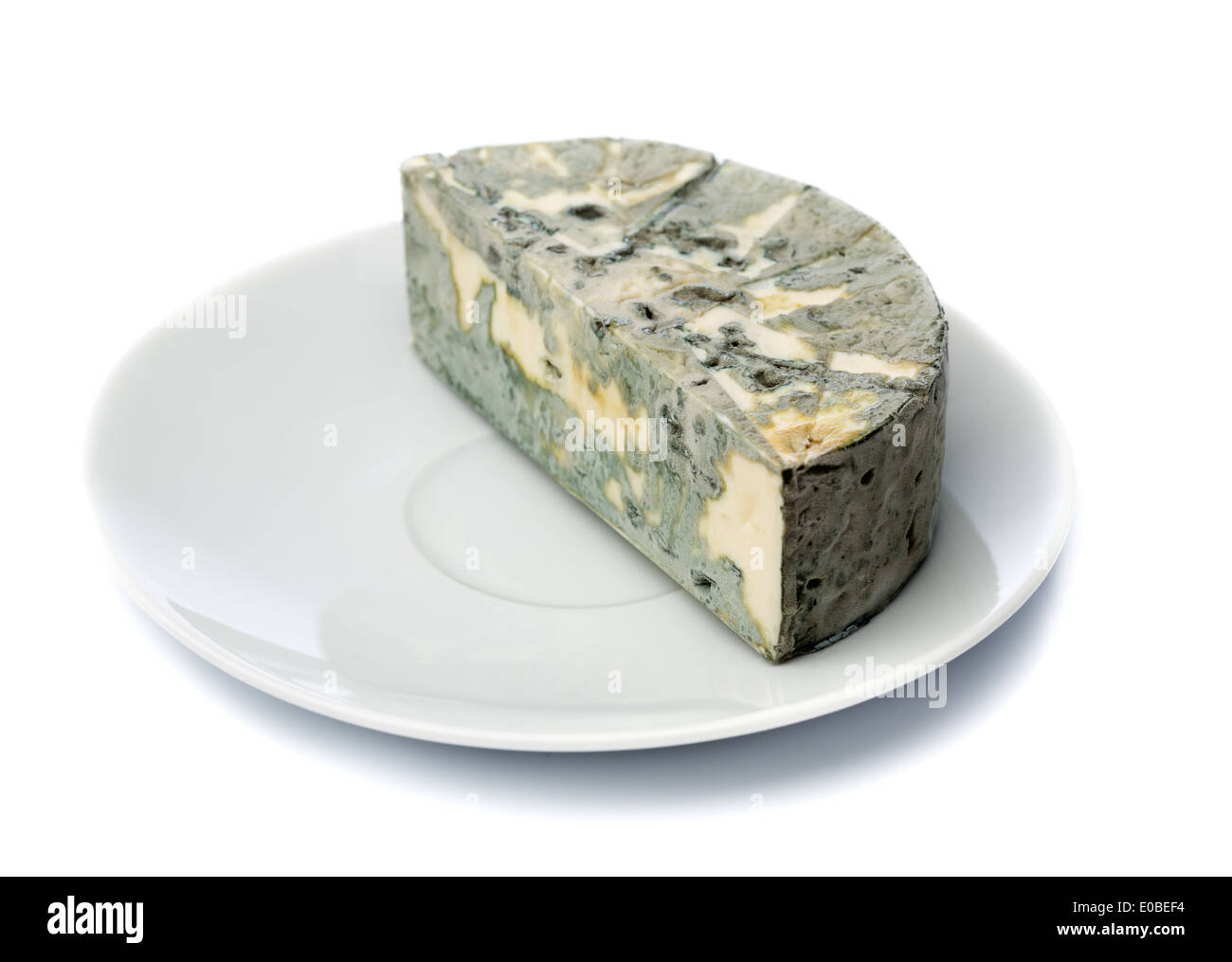 Cheese with black mold on a plate for food lovers. Isolate on white