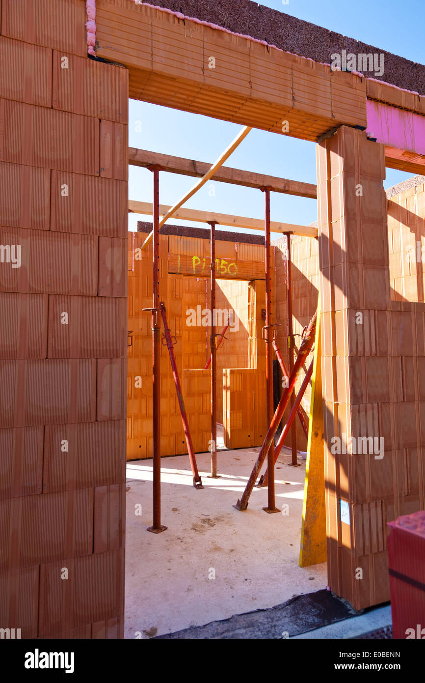 A brick shell of a house in massive construction. Established in bricks ...