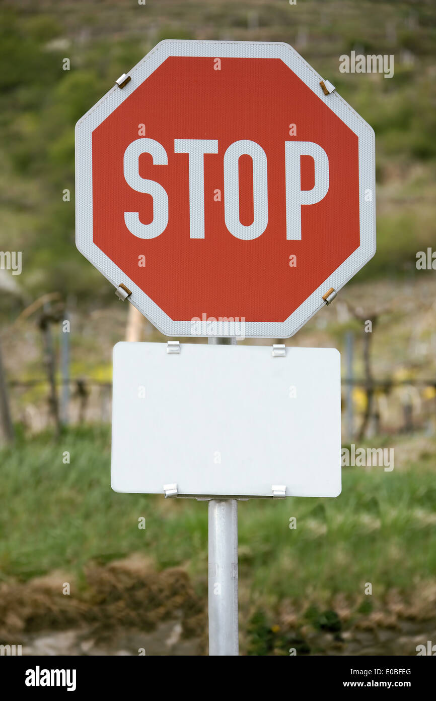 A stop board with an empty sign for text clearance., Eine Stoptafel mit einem leerem Schild fuer Textfreiraum. Stock Photo
