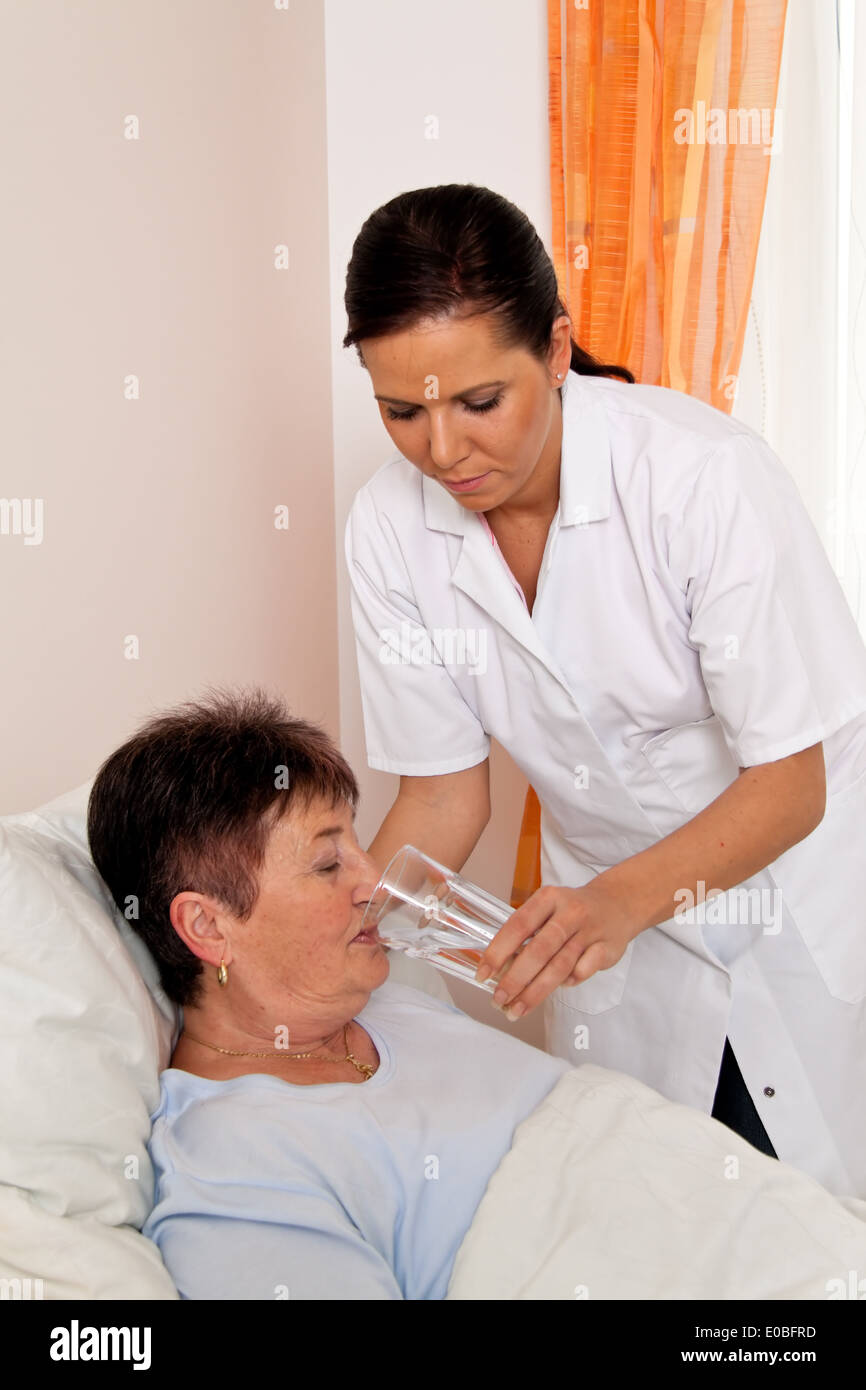 a nurse with geriatric care of senior citizens in the old people's home, eine Pflegerin bei Altenpflege von Senioren im Altenhei Stock Photo