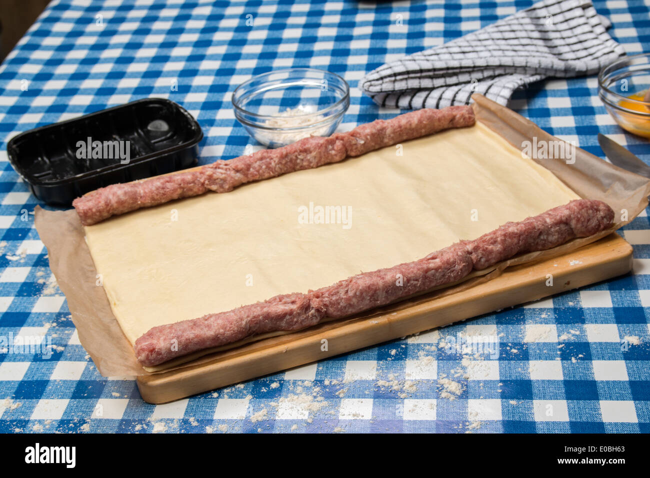 Making sausage rolls using ready rolled pastry, sausages in place ready