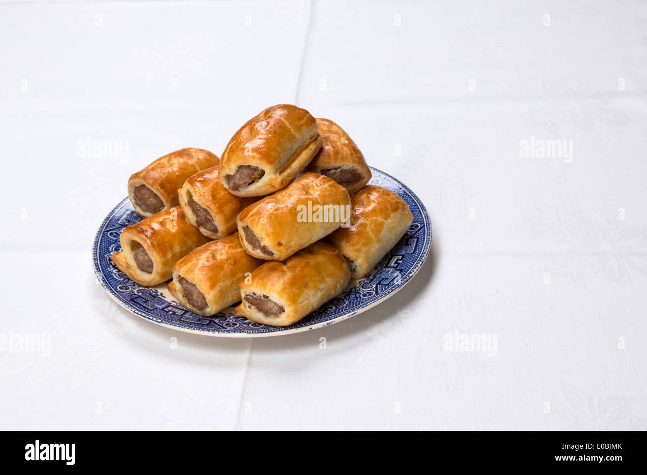 Making sausage rolls using ready rolled pastry, finished rolls on a plate(57 of 58) Stock Photo