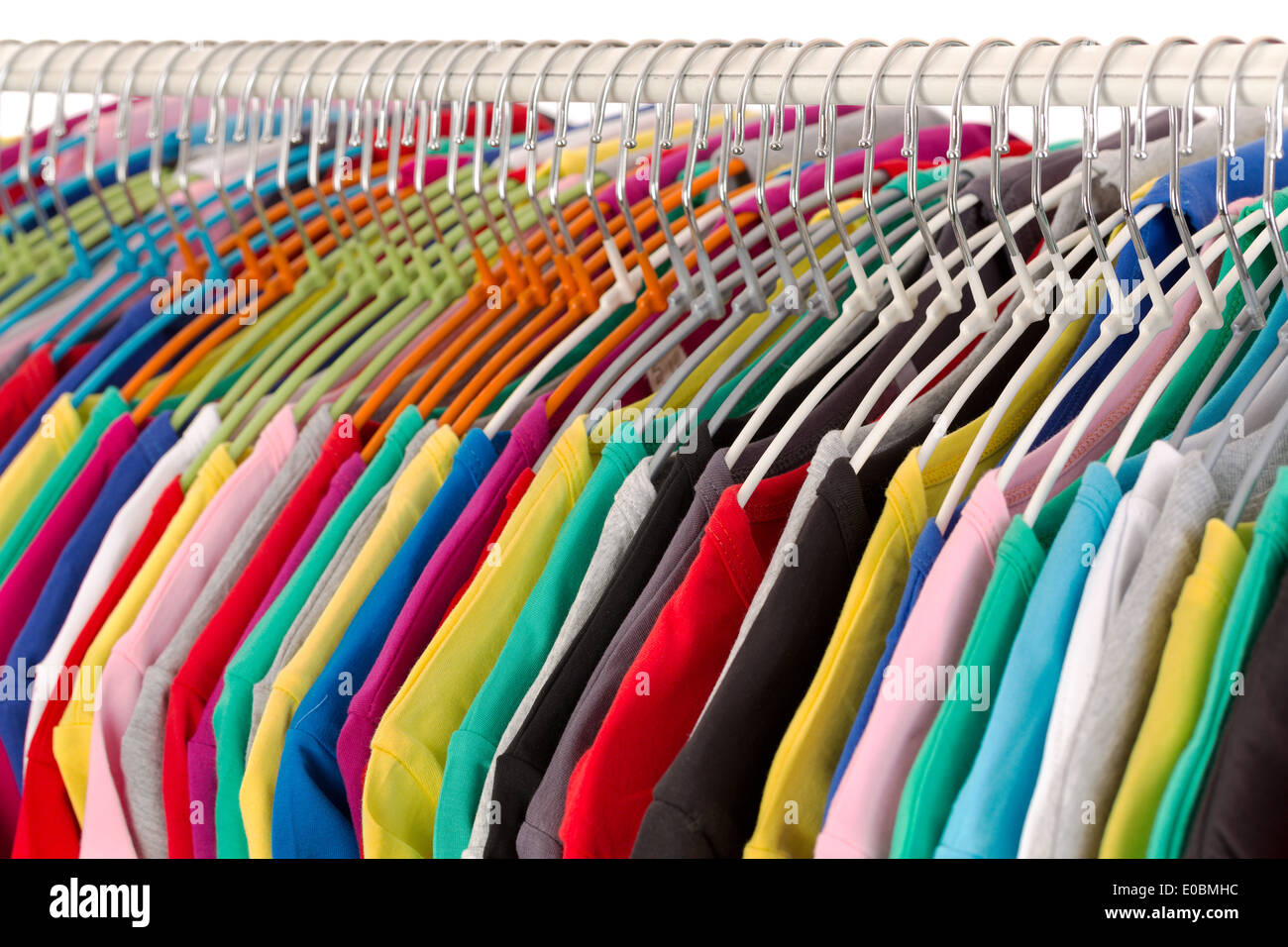 Colored shirts on hangers steel closeup. Isolate on white. Stock Photo