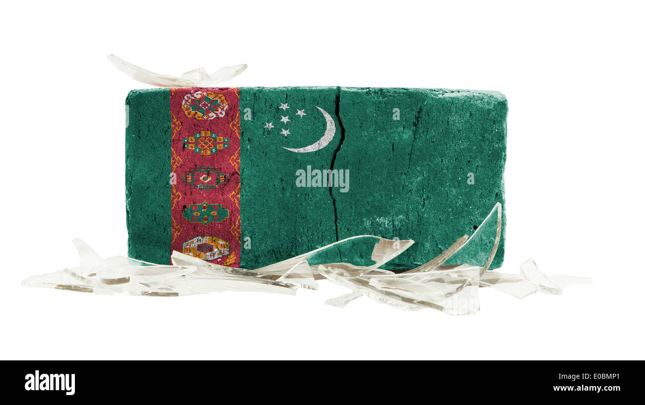 Brick with broken glass violence concept flag of Turkmenistan Stock