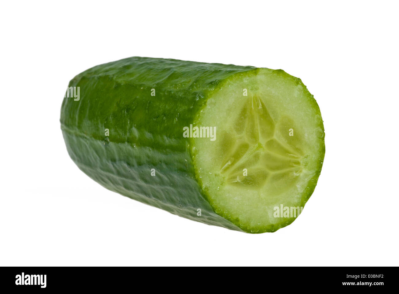 A cucumber lies on a white background, Eine Gurke liegt auf einem weissen Hintergrund Stock Photo