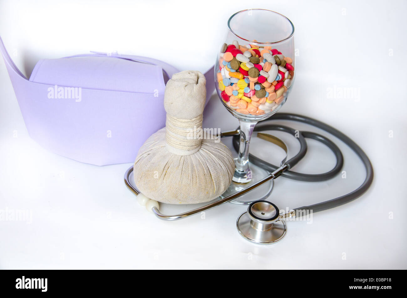 compress ball herbal with medicine and stethoscope Stock Photo