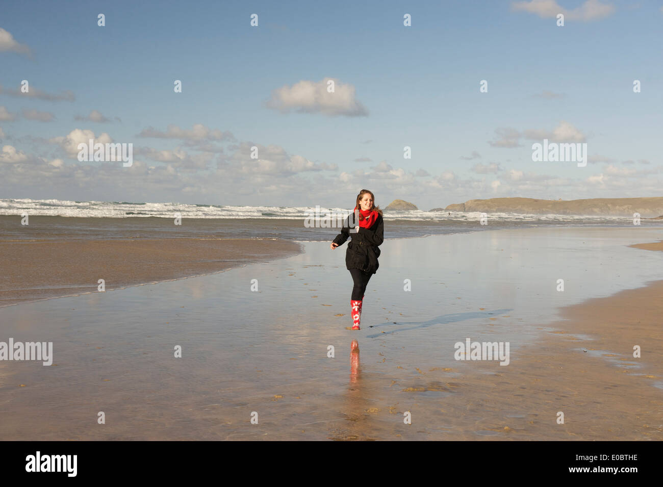 Young Woman running on beautiful Cornish Beach Stock Photo
