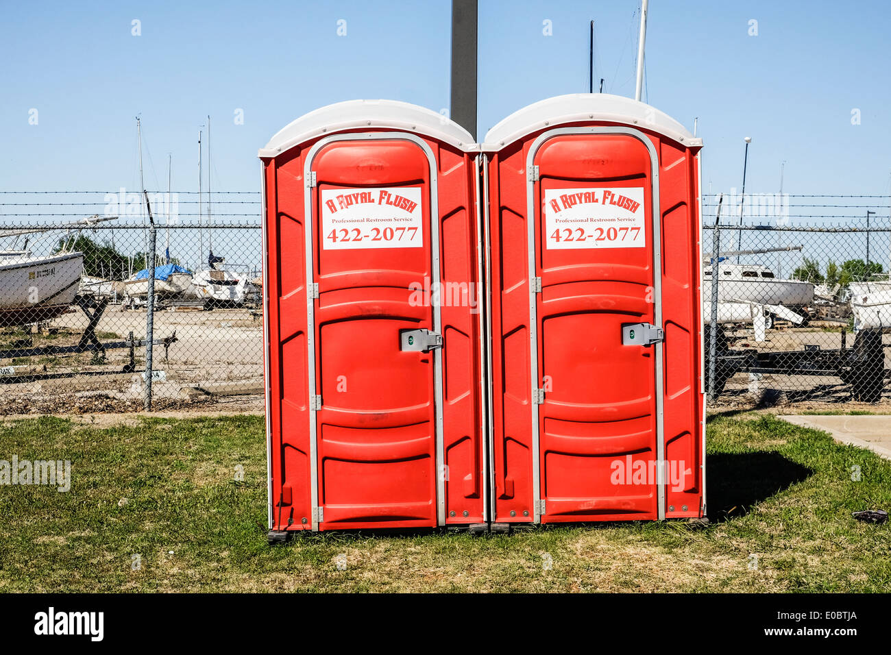 port-a-potties outside the fence of a boatyard in Oklahoma City, Oklahoma, USA. Stock Photo