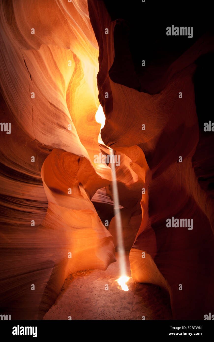 A shaft of warm light captured in the Upper Antelope Canyon, Navajo Nation, Arizona. Stock Photo