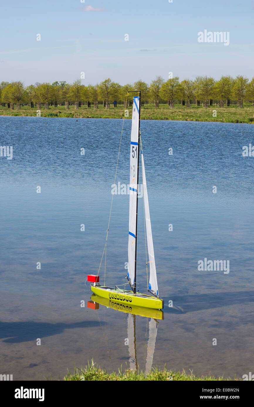 Model yacht sailing on Rick Pond, Home Park, Kingston, Surrey, England